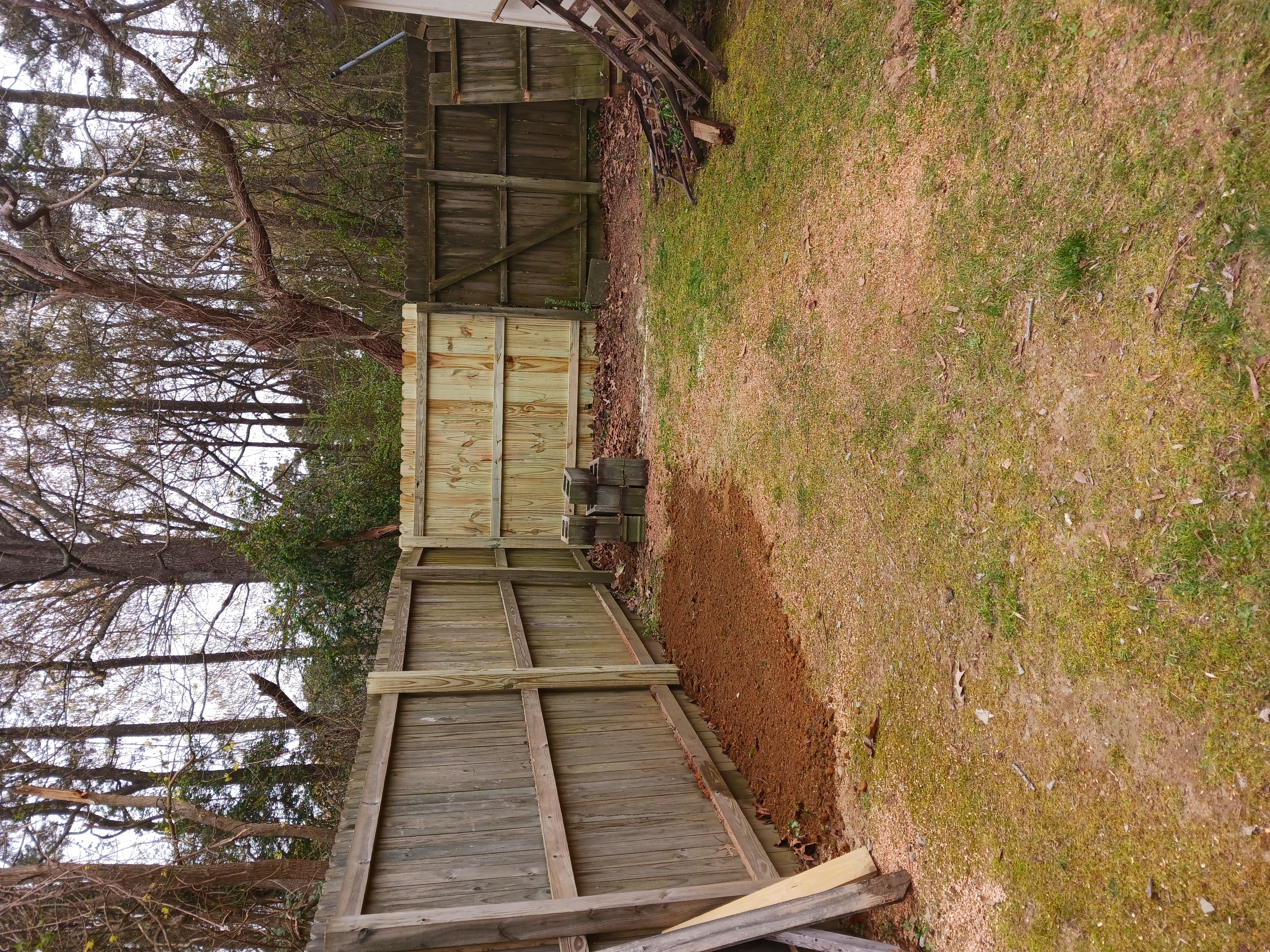 New wood fence section blended into an existing backyard fence line.