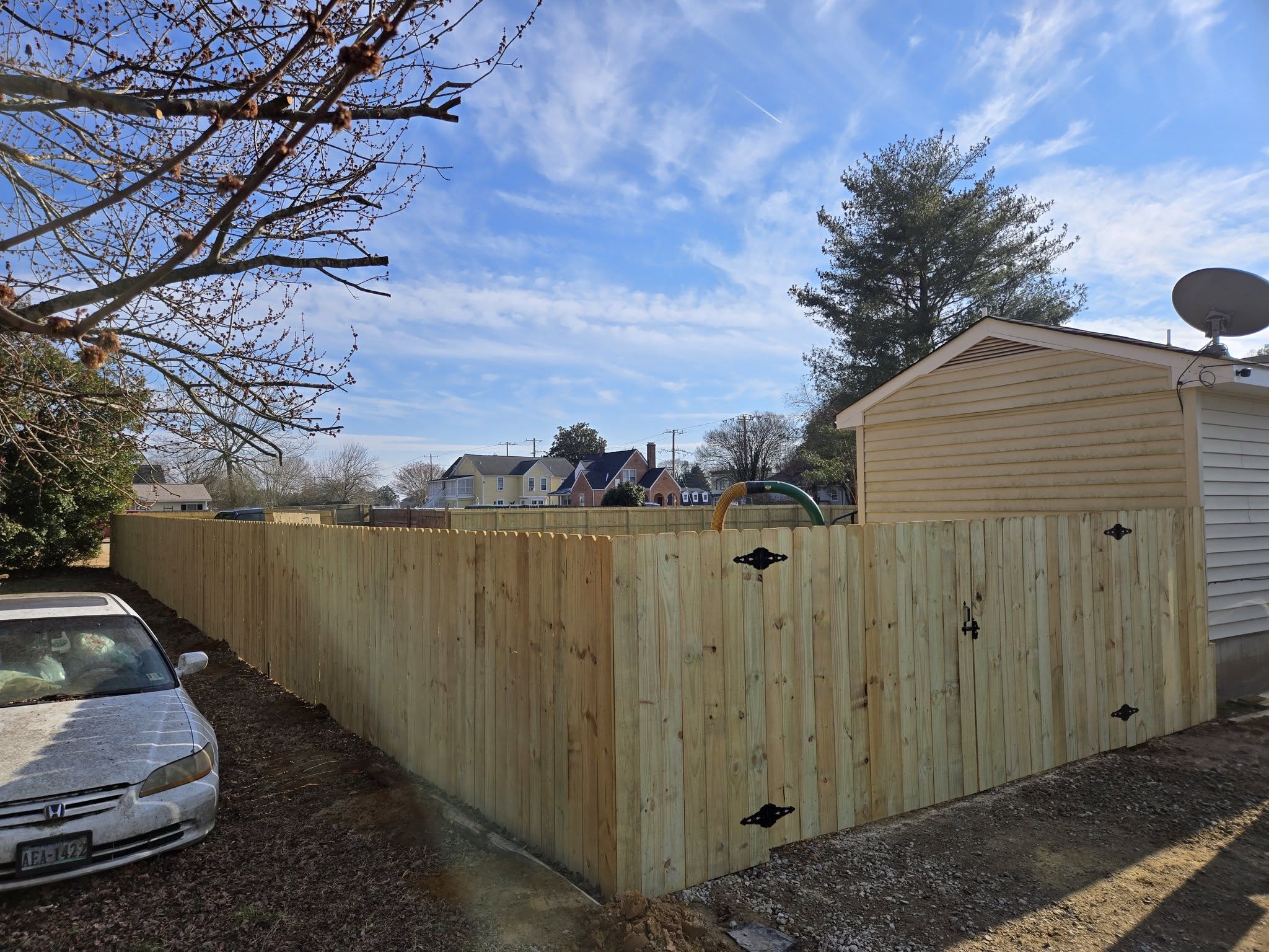 Wood privacy fence and gate installed by A and D Fencing at a residential property.